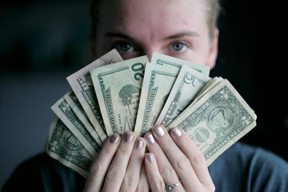 Woman holding dollar bills